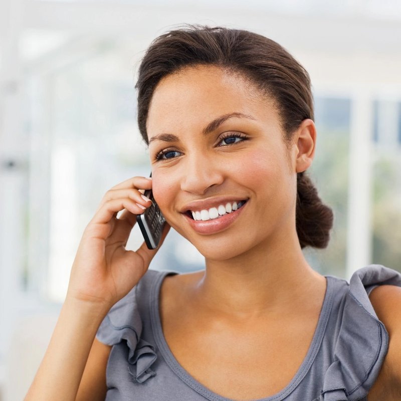 Woman talking on phone and smiling in Chicago, IL